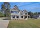 Stunning two-story house featuring white siding, black shutters, and a spacious front yard at 141 Frontier Way, Mcdonough, GA 30253