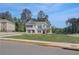 Two-story home featuring black shutters, white siding, and a well-manicured lawn at 141 Frontier Way, Mcdonough, GA 30253