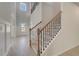 Bright foyer featuring hardwood floors, white walls, and staircase with iron spindles and wood railing at 141 Frontier Way, Mcdonough, GA 30253