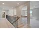 Bright hallway with iron railing, access to bathroom and bedroom at 141 Frontier Way, Mcdonough, GA 30253