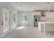 Eat-in kitchen space with stainless appliances, white cabinets, island, and natural light from two windows at 141 Frontier Way, Mcdonough, GA 30253