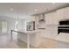 Bright kitchen features a large center island, stainless steel appliances, and white cabinetry at 141 Frontier Way, Mcdonough, GA 30253