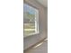 Bright living room featuring hardwood floors, white walls, and a large window with neighborhood view at 141 Frontier Way, Mcdonough, GA 30253