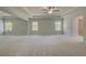 Large living room has neutral paint and plush carpeting at 141 Frontier Way, Mcdonough, GA 30253