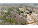 High angle aerial shot of the home surrounded by dense trees in a residential neighborhood at 1925 Emerald Dr, Cumming, GA 30040