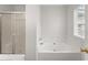 Bathroom featuring a shower and a tub next to a window at 1925 Emerald Dr, Cumming, GA 30040