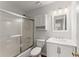Bathroom featuring a shower and bathtub combo with glass doors, updated vanity and modern lighting at 1925 Emerald Dr, Cumming, GA 30040