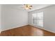 Comfortable bedroom featuring hardwood floors, a ceiling fan, and a window at 1925 Emerald Dr, Cumming, GA 30040