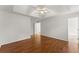 Bedroom boasts hardwood floors, a ceiling fan, and a door leading to the bathroom at 1925 Emerald Dr, Cumming, GA 30040