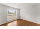 Cozy bedroom with hardwood floors and a window overlooking the garden at 1925 Emerald Dr, Cumming, GA 30040