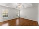 Bright bedroom featuring hardwood floors, a ceiling fan, and natural light from two windows at 1925 Emerald Dr, Cumming, GA 30040