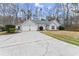 Inviting single-story home with gray siding, arched windows, a two-car garage, and a well-maintained lawn at 1925 Emerald Dr, Cumming, GA 30040