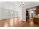 Bright and open living space with hardwood floors, arched windows, kitchen view, and ceiling fans at 1925 Emerald Dr, Cumming, GA 30040