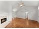 Spacious living room with hardwood floors, a fireplace, ceiling fan, and a doorway at 1925 Emerald Dr, Cumming, GA 30040