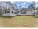 View of the home's backyard featuring the sunroom addition and mature trees at 1925 Emerald Dr, Cumming, GA 30040