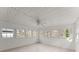 Neutral sunroom featuring tile floors, six windows and a ceiling fan for lighting at 1925 Emerald Dr, Cumming, GA 30040