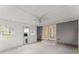 Neutral sunroom featuring tile floors, six windows, a ceiling fan, gray walls and two access doors at 1925 Emerald Dr, Cumming, GA 30040