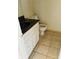 Convenient powder room featuring vanity with marble counter, sink and tiled floor at 207 Tiburon Dr, Stonecrest, GA 30038