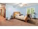 Comfortable bedroom with blue walls and a large window offering natural light at 613 Rock Springs Pass, Dallas, GA 30157