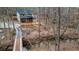 Charming home surrounded by mature trees and a quaint bridge leading to the property at 613 Rock Springs Pass, Dallas, GA 30157