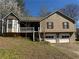 Charming home featuring a front-facing two car garage, quaint porch, and neutral siding at 1125 Durrell St, Austell, GA 30106