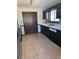 Kitchen featuring tiled flooring, dark cabinetry, and stainless steel appliances at 1125 Durrell St, Austell, GA 30106