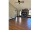 Spacious living room featuring beautiful wood floors, a ceiling fan, and stone fireplace at 1125 Durrell St, Austell, GA 30106