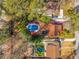 Stunning aerial view of the home with two pools and a private, wooded backyard at 1175 Kingsley Ne Cir, Atlanta, GA 30324