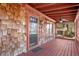 Relaxing screened-in porch with wood flooring, ceiling fan, and unique wood shingle exterior at 1175 Kingsley Ne Cir, Atlanta, GA 30324
