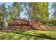 Grassy lawn and wooden deck in a wooded backyard at 1175 Kingsley Ne Cir, Atlanta, GA 30324