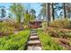 Lush backyard with a stone path leading to a house with a screened-in porch at 1175 Kingsley Ne Cir, Atlanta, GA 30324