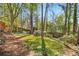 The wooded backyard features lush green grass, a shed and privacy fence at 1175 Kingsley Ne Cir, Atlanta, GA 30324