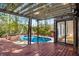 A covered deck leads to a swimming pool and hot tub in the backyard at 1175 Kingsley Ne Cir, Atlanta, GA 30324