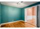 Cozy room with hardwood flooring, turquoise colored walls, and a view into another room at 1175 Kingsley Ne Cir, Atlanta, GA 30324