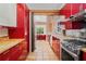 Modern kitchen features red cabinets, stainless steel appliances, and tile flooring at 1175 Kingsley Ne Cir, Atlanta, GA 30324