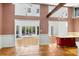 View of kitchen with terra cotta tile flooring flowing into a sunroom with access to an outdoor pool at 1175 Kingsley Ne Cir, Atlanta, GA 30324