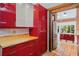 Kitchen with custom red cabinets, stainless steel refrigerator, and tile flooring at 1175 Kingsley Ne Cir, Atlanta, GA 30324