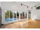 Living room with hardwood floors, a wall of windows overlooking the pool and track lighting at 1175 Kingsley Ne Cir, Atlanta, GA 30324