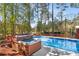 Inviting in-ground pool and hot tub surrounded by a wooden deck and lush trees, perfect for relaxation at 1175 Kingsley Ne Cir, Atlanta, GA 30324