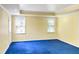 Spacious bedroom with blue carpet, recessed lighting, and a wall of windows at 10890 Regal Forest Dr, Suwanee, GA 30024