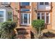 Elegant home entrance with a decorative glass door, flanked by manicured greenery at 10890 Regal Forest Dr, Suwanee, GA 30024