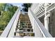 Exterior view of backyard wooden staircase leading up to the home at 10890 Regal Forest Dr, Suwanee, GA 30024