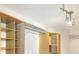 Bright walk-in closet with custom shelving, hanging rods, and modern track lighting at 10890 Regal Forest Dr, Suwanee, GA 30024