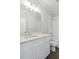 Bathroom featuring a large mirror and white cabinets with white tiling in the shower at 1158 Welch Sw St, Atlanta, GA 30310