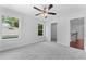 Light-filled bedroom with plush carpeting, fan, and ensuite closet at 1158 Welch Sw St, Atlanta, GA 30310