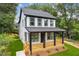 Charming two-story home with a welcoming front porch and freshly manicured lawn at 1158 Welch Sw St, Atlanta, GA 30310