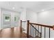Hallway at the top of the stairs with hardwood floors and doors to other rooms at 1158 Welch Sw St, Atlanta, GA 30310