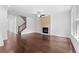 Bright living room with a stone fireplace, hardwood floors, and staircase at 1158 Welch Sw St, Atlanta, GA 30310