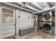 Basement laundry area featuring modern washer/dryer units, utility sink, and painted brick walls at 333 Drexel Ave, Decatur, GA 30030