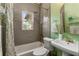 Charming bathroom with gray tiled walls, antique brass fixtures, and a stained-glass window at 333 Drexel Ave, Decatur, GA 30030